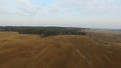 4K. Flight above freshly cultivated fields in spring, aerial panoramic view