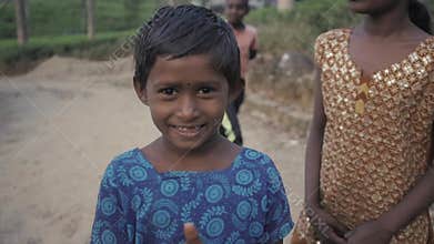 NUWARA ELIYA, SRI LANKA - JANUARY 15 2017 : Poor Indian beggar girls and boys on tea plantation, tourist give money