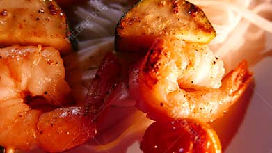 Thai Chinese fusion cuisine, noodles with prawns fried on a skewers. Closeup