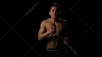 Sportsman running on black background at fast pace. Middle distance