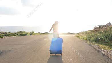 Happy traveler woman running with suitcase