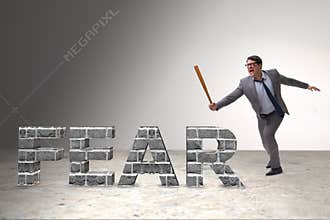 The angry man with baseball bat hitting fear word