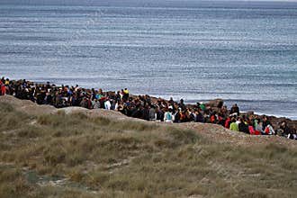 People in a peaceful demonstration on a beach to protect it from construction