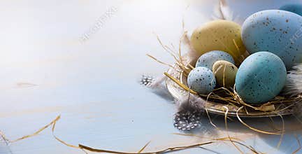 Happy Easter; Easter eggs on blue table background. Holidays vie