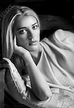 Black and white portrait of reclining feminine blonde woman