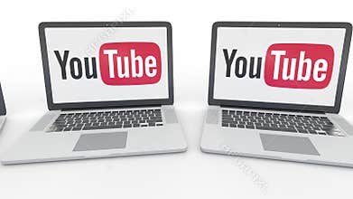Notebooks with YouTube logo on the screen. Computer technology conceptual editorial 4K clip, seamless loop
