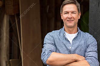 Happy Middle Aged Man Arms Folded by His Garage