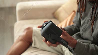 Male hands inserting mobile phone into VR glasses