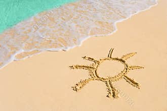 Drawing sun on beach