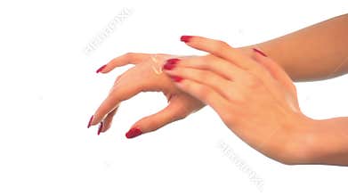 Young girl causes cream on the hands close-up