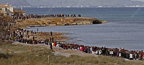 People in a peaceful demonstration on a beach to protect it from construction