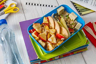 Healthy school lunch box on white wood background