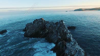 Aerial view. camera flies around the rocks in the sea Birds on the island. camera zooms