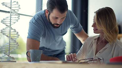 Team of two scientists working on project in friendly atmosphere