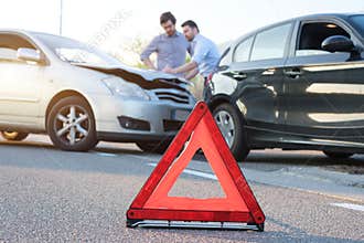 Two men reporting a car crash for insurance claim