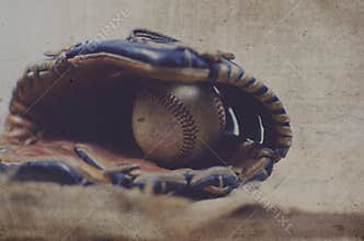Old vintage ball in leather mitt, grunge baseball equipment image. Great for sports team or hardball player graphic.