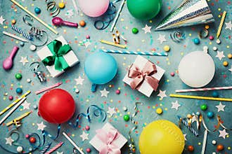 Birthday party background with colorful balloon, gift, confetti, cap, star, candy and streamer. Flat lay style. Festive card.