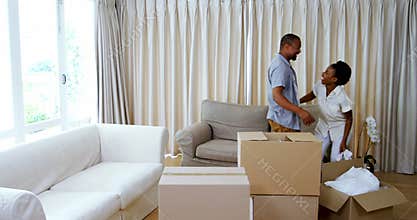 Couple embracing each other in living room