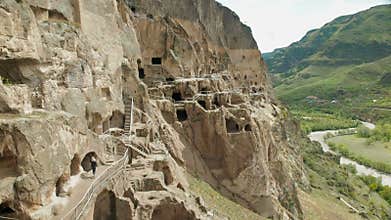A tourist examines the sights of Georgia Vardzia cave monastery.