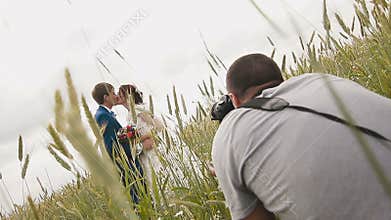Photographer taking pictures couple of newlyweds