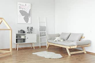 White teddy bear on grey sofa