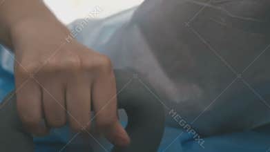 Woman grasps the grip of the chair during childbirth