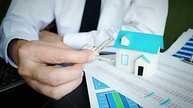 Man taking keys from house in real estate office.