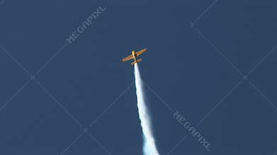 Aerobatics in blue sky with trailing smoke