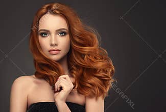 Red haired woman with voluminous, shiny and curly hairstyle. Frizzy hair.