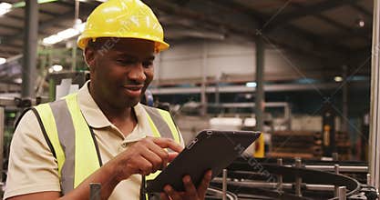 Worker using digital tablet in bottle factory