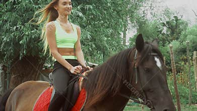 Happy girl rides on horseback