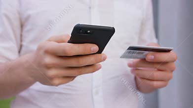 A Man Using a Mobile Phone Outdoors