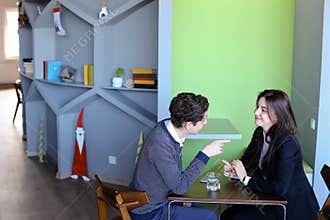 Young men and women communicate and share secrets, sitting in in