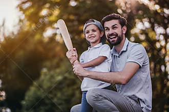 Dad with son playing baseball