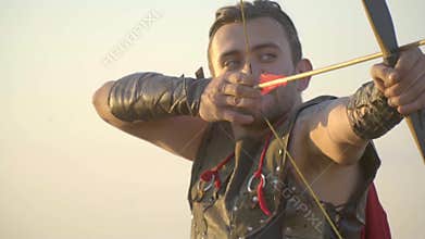 The archer gets angry and kneels and tightens the string