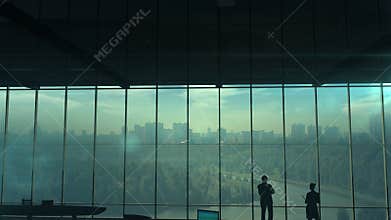 Silhouettes of office employees on different floors