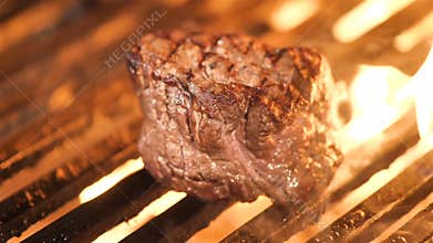 Grilling steak with a piece of melting butter