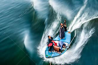 Egyptian craftsmen sell to tourists cruising past on Nile river