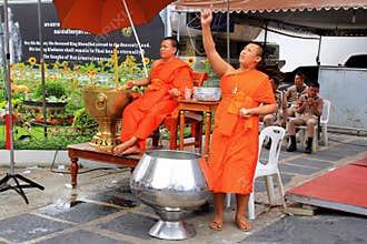 Two Buddhist monks are working near to temple.