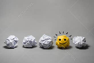 Yellow crumpled paper ball.Business creativity,leadership concept