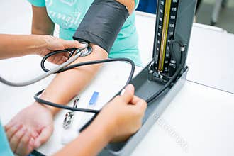 Nursing students are training measurement of blood pressure with manual sphygmomanometer and stethoscope at nursing school.