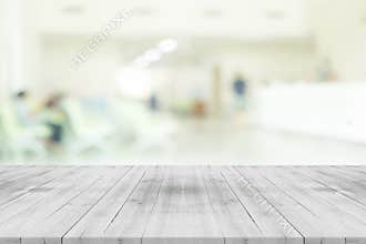 Empty white wood table top on blur hospital interior