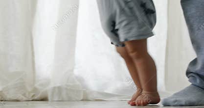 Baby boy 1 year old walking his first steps