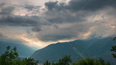 Snowcapped mountain ridges and peaks with moving clouds over the Alps in summer, Torino Province, Italy. Time lapse.