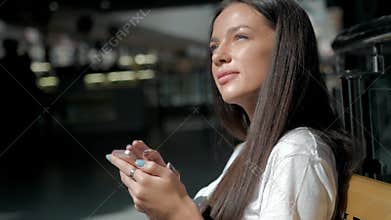 Woman brunette with phone smiling, close up. Young business woman professional happy. Beautiful multiethnic brunette