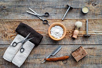 Barbershop. Men`s shaving and haircut. Brush, razor, foam, sciccors on wooden table background top view