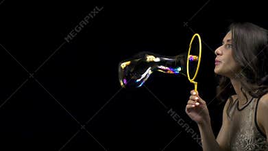 Brunette young girl blowing bubbles