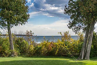 Cedars Frame Dramatic Sky Over Lake Michigan