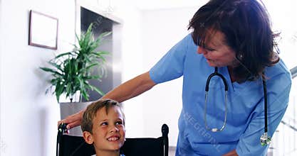 Nurse talking to disable boy