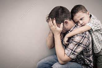 Sad son hugging his dad